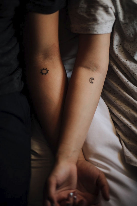 sun and moon tattoos on arms